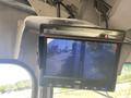 A monitor displaying a view from a rear camera of a 2008 Ford Econoline showing a driver's side perspective