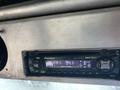 A Pioneer car radio with a digital display showing FM station 94.1 and various settings visible