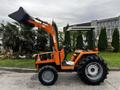 A 2001 Agco ST40 tractor with an orange color scheme features a front loader attachment and large black tires