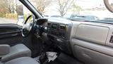 Interior view of a 2008 Ford F-650 featuring a gray dashboard with radio controls and a gear shift on the floor