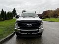 Front view of a 2020 Ford F-350 SD with a black grille and a yellow light on top