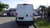 A white 2017 RAM Promaster van viewed from the rear with vertical doors and a simple design