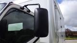 Close-up of the side mirror of a 2016 Hino 195 truck showcasing its black color and curved design