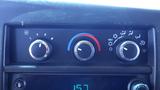 Dashboard controls for climate control featuring three dials for fan speed temperature and airflow direction on a 2012 GMC Savana