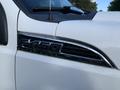 Close-up of a 2013 Ford F-450 Super Duty badge on the side of a white truck