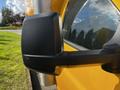 Detail of the side mirror on a yellow 2017 GMC Savana van