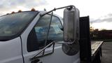 A 2008 Ford F-650 with a prominent side mirror and orange roof lights on top of the cab