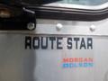 A silver delivery vehicle with the text "ROUTE STAR" and "MORGAN OLSON" displayed prominently on its side