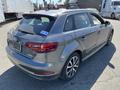 A gray 2016 Audi A3 with a sleek design visible from the rear angle featuring sporty wheels and a hatchback style