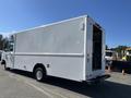 A white 2007 Ford Econoline cargo van with a boxy design and double rear doors visible