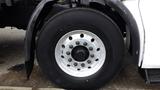 Close-up of a large silver wheel on a 2007 Autocar WXLL truck featuring multiple lug nuts and a thick black tire