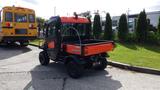 A 2018 Kubota RTV X1100C utility vehicle with an orange and black exterior featuring a cargo bed in the back and four wheels