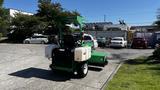 A 2017 Laymor SweepMaster 300 compact street sweeper with a green and white color scheme and a front-mounted sweeping brush