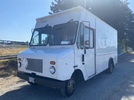 A white 2008 Ford Econoline truck with a simple design featuring large windows and a front grille with circular headlights