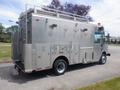 A 2007 Morgan Olson Workhorse W42 truck with a metallic exterior featuring multiple compartments and storage units on the sides and roof-mounted equipment