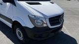 2016 Mercedes-Benz Sprinter van with a white exterior and black front bumper showcasing the iconic Mercedes logo on the grille and headlights