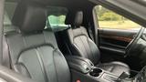 Interior view of a 2013 Lincoln MKT featuring black leather front seats with a sleek design and a console between them