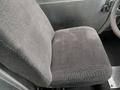 A gray upholstered driver's seat from a 2005 Freightliner MT45 Chassis with a textured fabric surface