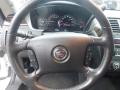 A close-up view of the steering wheel and dashboard of a 2008 Cadillac Limousine showcasing the brand logo and various instrument readings