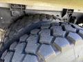 Close-up of two rugged tires of a 2009 International 7500 showcasing deep treads for traction and durability