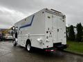 A white 2005 Workhorse W-Series delivery truck with blue stripe details parked, featuring two rear doors and a side access door