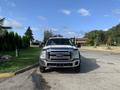 A 2013 Ford F-450 Super Duty truck is parked facing the camera with a chrome grille and front bumper showing its design and rugged appearance