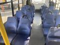 Interior view of a 2018 Chevrolet Express with blue vinyl seats arranged in rows and no passengers seated