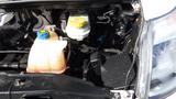 The engine compartment of a 2017 RAM Promaster showing various components including a coolant reservoir and a battery