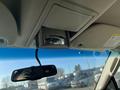 The interior of a 2013 Ford Expedition with a rearview mirror and an overhead compartment view visible