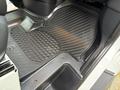 A black rubber floor mat inside a 2019 Mercedes-Benz Sprinter with a textured design and a raised border