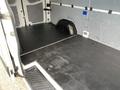 Interior view of a 2017 Mercedes-Benz Sprinter cargo van showcasing the spacious empty cargo area with a black rubber floor and paneling