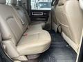 Interior view of a 2010 Dodge Ram showcasing the rear seating area with leather seats and floor mats