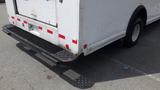 Rear view of a white 2011 Ford Econoline van with a black grated bumper and red reflective tape