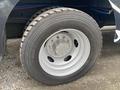 Close-up of a wheel with a silver rim and a thick tire on a 2011 Ford Utilimaster Food Truck