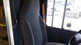 A grey fabric driver's seat inside a 2011 Ford Econoline van