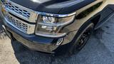 A black 2018 Chevrolet Tahoe with a chrome grille and distinctive headlights