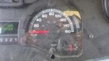 Close-up of the speedometer and gauge cluster of a 2011 Ford Econoline displaying speed in kilometers per hour and miles per hour