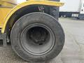 A close-up of a worn out tire from a 2000 Hyster 120 forklift with visible tread and markings on the sidewall