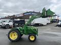 2003 John Deere 790 tractor with a green and yellow color scheme featuring a front loader raised high