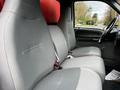 Two gray cloth seats in the interior of a 2008 Ford F-750 with seatbelts and armrests visible