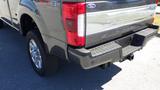 2017 Ford F-350 SD with a gray exterior showing the rear view and a prominent tailgate design featuring the Super Duty logo