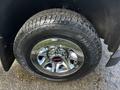 Close-up of a chrome wheel with a Hankook tire on a 2017 GMC Sierra 1500 showcasing the vehicle's branded emblem and tread pattern