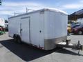 A 2010 Forest River enclosed trailer with a white exterior and dual axles attached to a hitch at the front