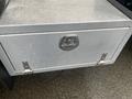 A metal storage box with a shiny handle attached to a 2021 Ford F-550 truck