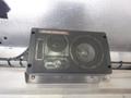 A black 3-way bass reflex speaker mounted on a metallic surface with visible wiring