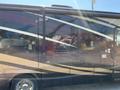 2008 Newmar Canyon Star 36 Foot Class A Motorhome with a sleek exterior featuring a combination of dark colors and bold stripes