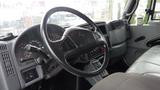 Interior view of a 2005 International 4300 truck featuring a steering wheel dashboard controls and gray upholstery