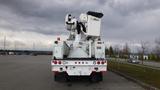 A 2008 International 7500 truck equipped with a hydraulic boom and basket for aerial work