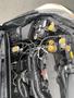 A 2014 Subaru Impreza engine compartment with various components including the battery several hoses and coolant reservoirs