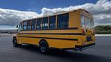 A yellow 2014 Freightliner Thomas diesel school bus parked with large windows and black trim